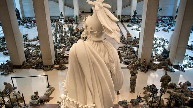 Members of the National Guard rest in the Capitol Visitors Center on Capitol Hill ahead of the impeaching of US President Donald Trump. Picture: AFP