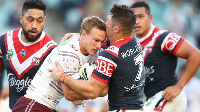 Manly halfback Daly Cherry-Evans is tackled by Roosters No. 7 Cooper Cronk.