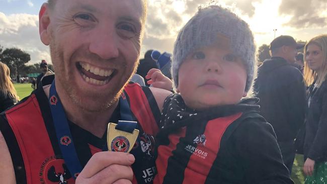 Burkett with son Elijah after winning the 2020 RMFL premiership. Picture: Ty Burkett