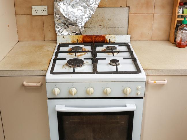 Exposed asbestos behind the oven, which does not work. Picture: Ian Currie