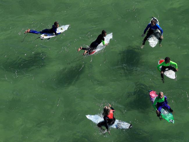 Surfers at play off Byron Bay. Picture: Adam Head