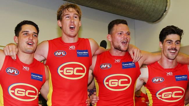 Tom Lynch (second from left) sings the club song after the Suns’ win with teammates Brayden Fiorini, Steven May and Alex Sexton. Picture: Getty Images