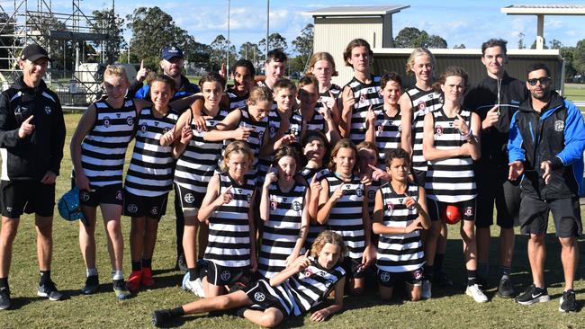 Siena Catholic College junior boys team celebrates winning the Sunshine Coast round of the AFLQ Secondary Schools Cup.