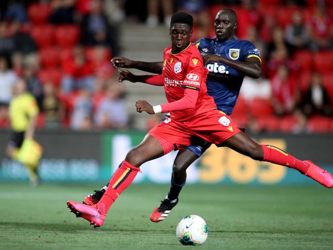 Mohamed Toure of United is tackled by Ruon Tongyik of the Mariners during the Round 19 A-League match between Adelaide United and Central Coast Mariners at Coopers Stadium in Adelaide, Friday, February 14, 2020. (AAP Image/Kelly Barnes) NO ARCHIVING, EDITORIAL USE ONLY