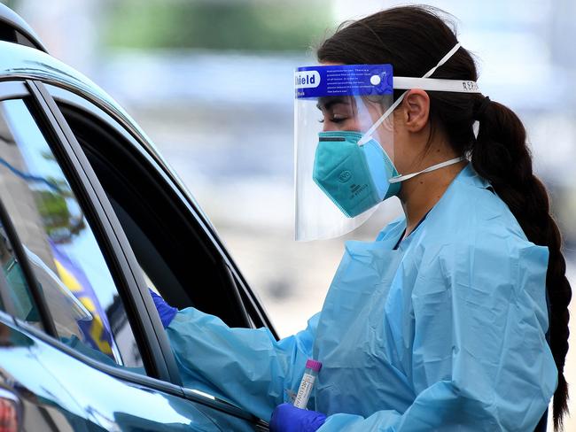 SYDNEY, AUSTRALIA - NewsWire Photos FEBRUARY, 22, 2021: NSW Health workers dressed in Personal Protection equipment (PPE) are seen at the St VincentÃs Hospital COVID-19 drive through testing clinic at Bondi Beach, Sydney. Australia has begun its Pfizer COVID-19 vaccination rollout this morning, with hopes 60,000 doses will be administered by the end of the week. NCA NewsWire/Bianca De Marchi