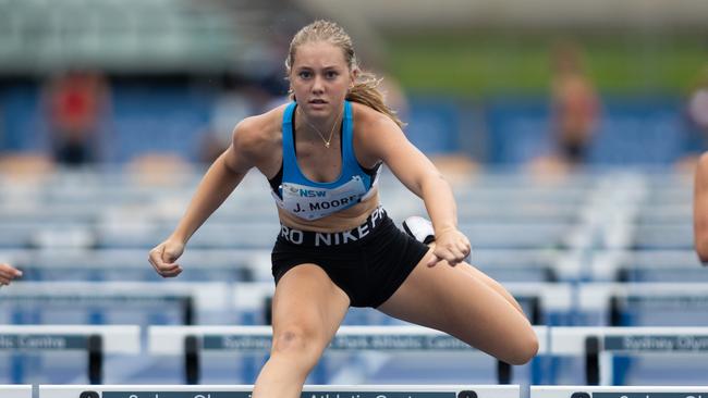 Jordan Moore from Caringbah South wins her hurdles race at the NSW Juniors meet.