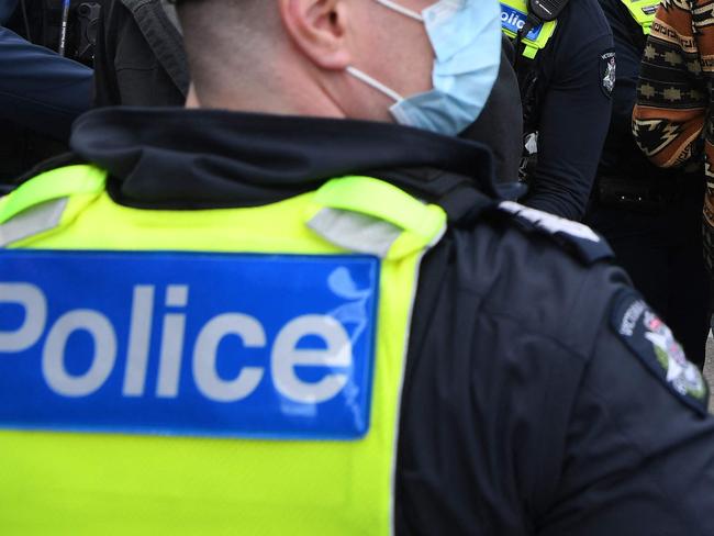 Police arrest an anti-vaccination and lockdown protester in Melbourne on May 29, 2021, as the city enters the second day of a seven-day lockdown after a spike in community transmission of the Covid-19 coronavirus. (Photo by William WEST / AFP)