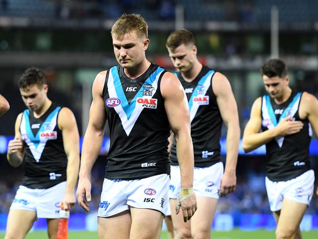 Ollie Wines and his Power teammates look dejected after losing the Round 22 loss at Marvel Stadium. Picture: Quinn Rooney/Getty Images