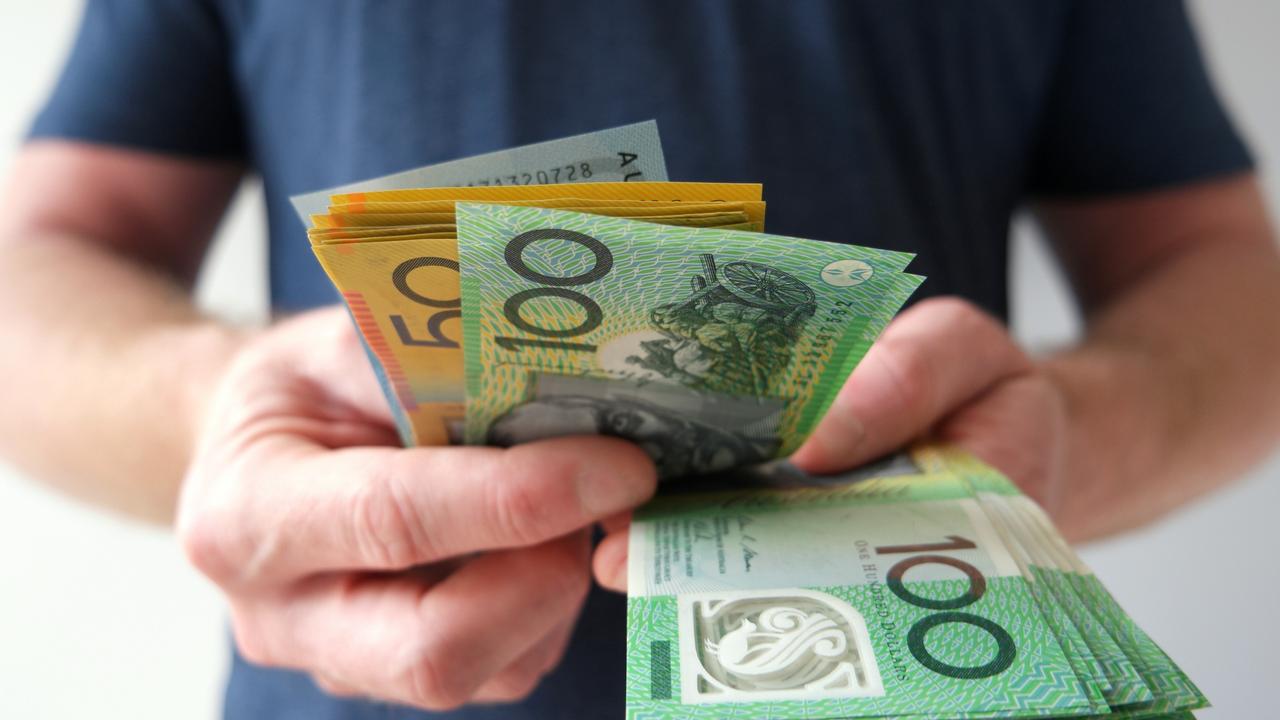 Man counting hundreds and fifties Australian dollar bills