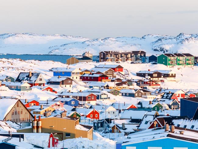 Lots of Inuit houses scattered on the hill in Nuuk city covered in snow with sea and mountains in the background, Greenland  Picture: istock