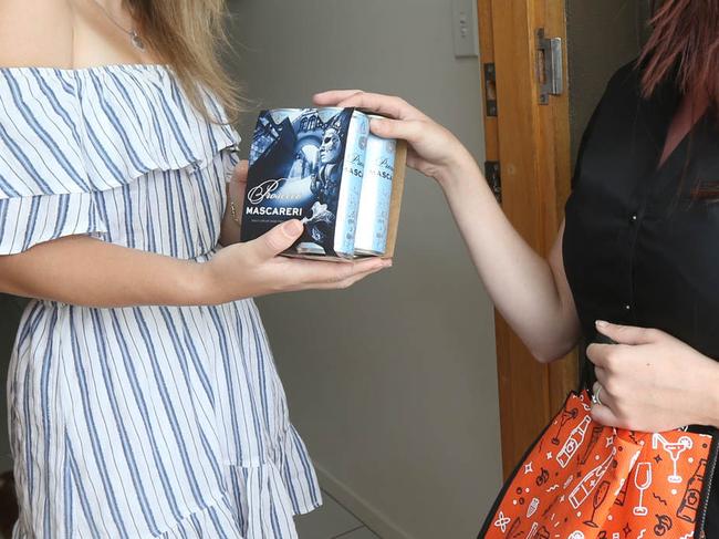 BWS have launched an express delivery service to get alcohol brought to you within the hour. L-R Krystal Ellis at her Hope Island home with BWS Delivery Person Amanda Clogg of BWS Coomera. Picture Mike Batterham