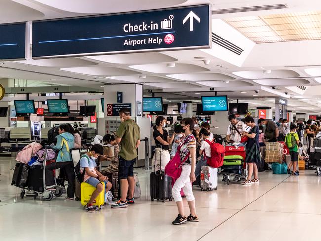 People line up to check in for Air China flight CA430 headed to Chengdu from Sydney airport on Saturday night. Picture: Monique Harmer