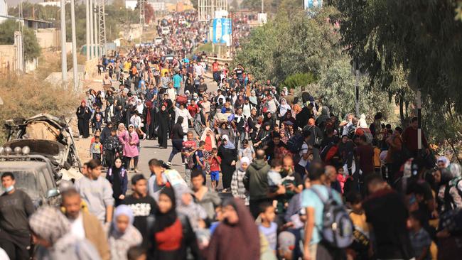 Palestinians families fleeing Gaza City and other parts of northern Gaza towards the southern areas, walk along a highway. Picture: MAHMUD HAMS / AFP