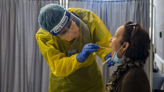 Northern Beaches Hospital Covid 19 clinic. Nurse Cathy Morris in the hot zone of the clinic performing a test on a patient. Image Matthew Vasilescu