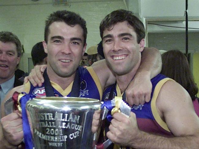 Chris and Brad Scott with Brisbane’s 2001 premiership trophy.