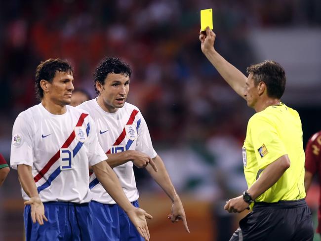 Referee Nikolay Golubev (R) shows the yellow card to Dutch defender Khalid Boulahrouz (L) and teammate midfielder Mark Van Bommel (C).