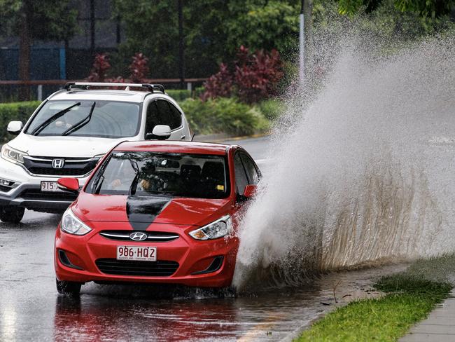 A car drives through flash flooding on Milton Road on November 19. Picture Lachie Millard