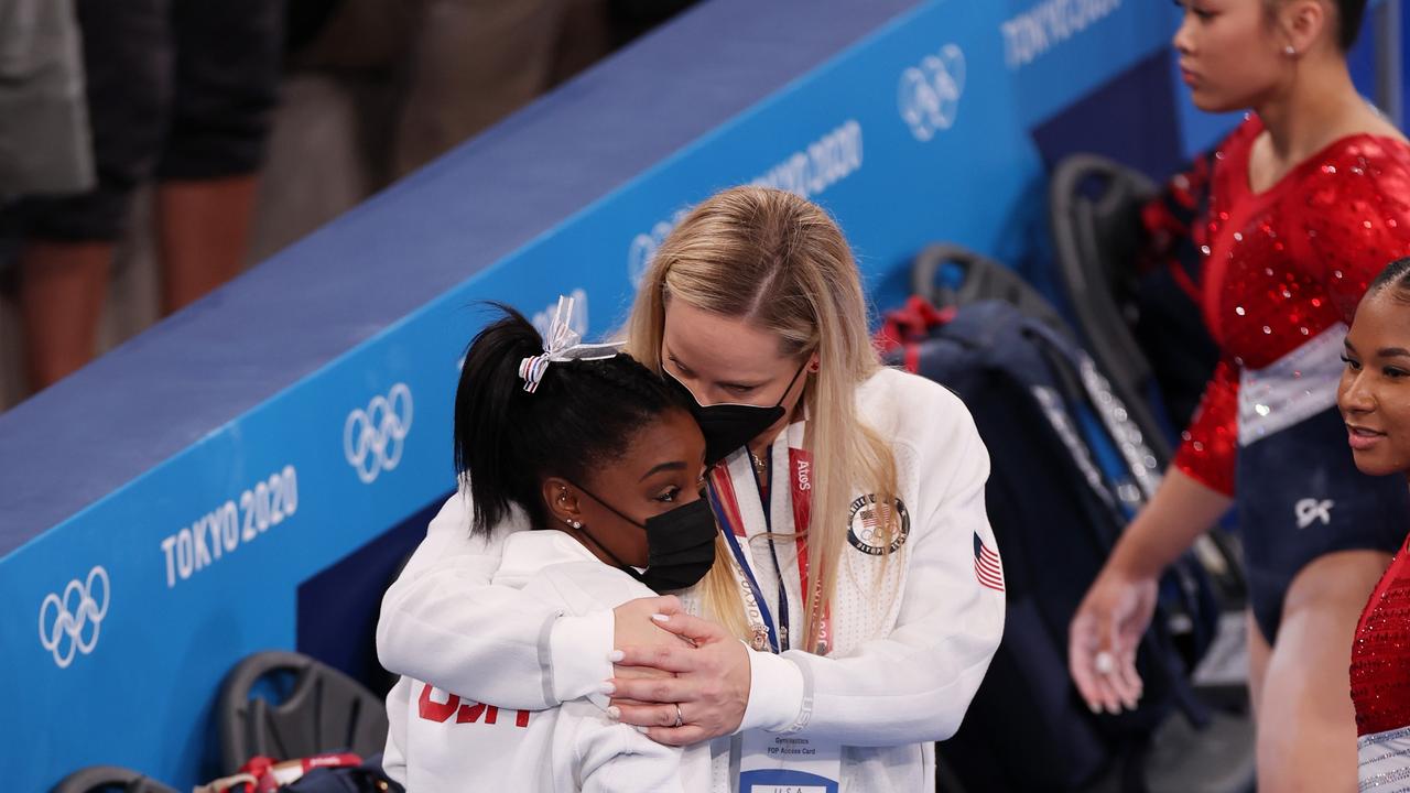 Simone Biles of Team United States is embraced by coach Cecile Landi