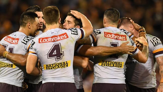 Broncos players celebrate their golden point win on Friday night.