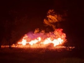 Neighbouring property owners on either side of the highway were on high alert with water trucks and dozers in case the fire spread to their homes. Picture: Kaiz-Anne Bryan