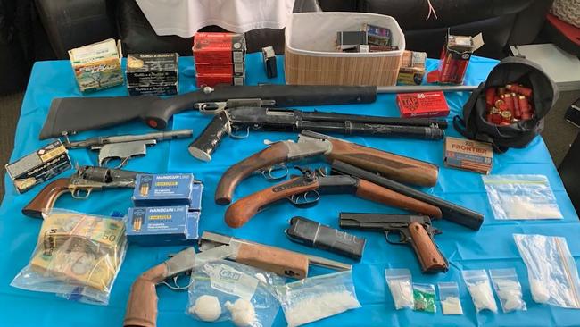 Weapons, drugs and cash were seized.