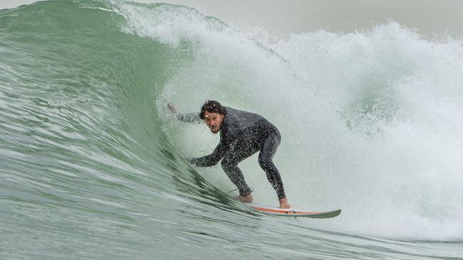 Tom Harrison tries out the man-made surf. Picture: Jay Town