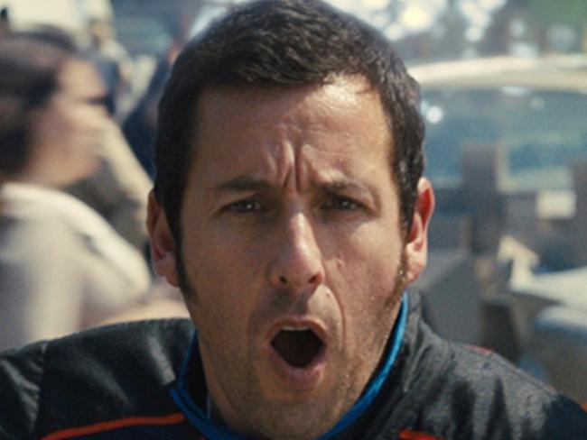 Violet (played by Michelle Monaghan), Sam Brenner (Adam Sandler), Ludlow (Josh Gad) and Q*bert in a scene from Columbia Pictures' film PIXELS