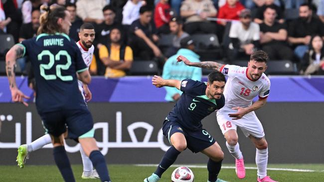 Syria's midfielder Jalil Elias vies for the ball against Australia's forward Bruno Fornaroli. Picture: Hector Retamal/AFP.