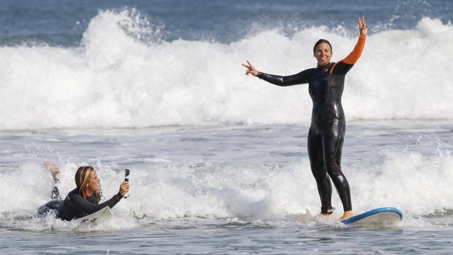 Courtney Conlogue surfing with Simona de Silvestro at Phillip Island.