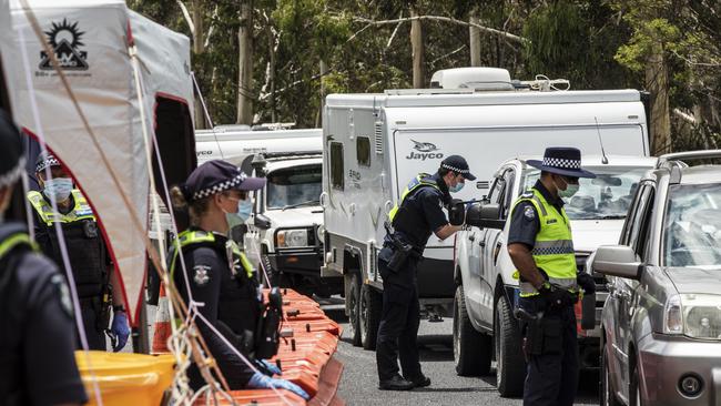 Police officers patrol and check for entry permits to Victoria at a border checkpoint in Mallacoota. Picture: Getty