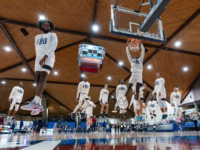 The Fairleigh Dickinson Knights men's basketball team completes its pre-game warm-up with a synchronised dunk in New Jersey. Picture: Ron Ratner