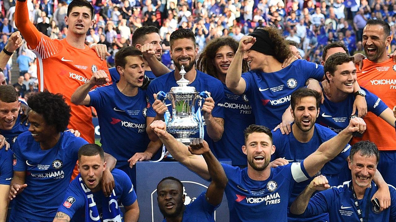 Chelsea players celebrate with the trophy after their victory.
