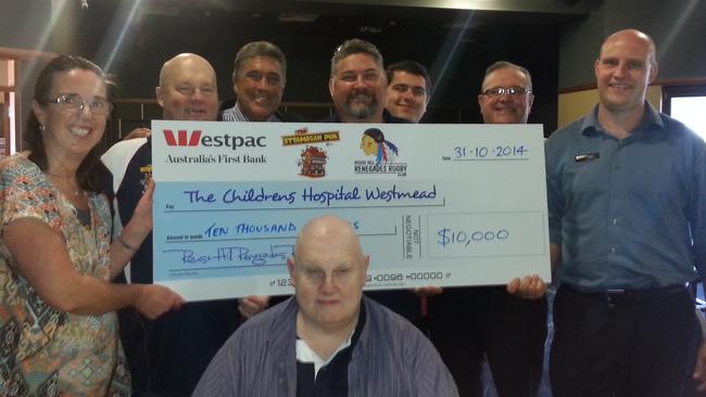 Rouse Hill Renegades present a $10,000 cheque to The Children's Hospital at Westmead's Fiona Nelson, left, at Ettamogah Pub in 2014: From left: David Smart, Glenn Smith, Lindsay Dodds, Jim Taggert, James Armstrong, Simon Robinson (Ettamogagh) and Russell Smith (seated)