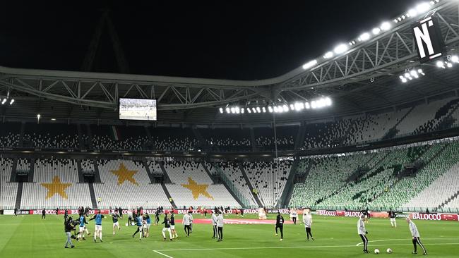 Juventus and Inter Milan players warm up in an empty stadium on Sunday. Picture: AFP