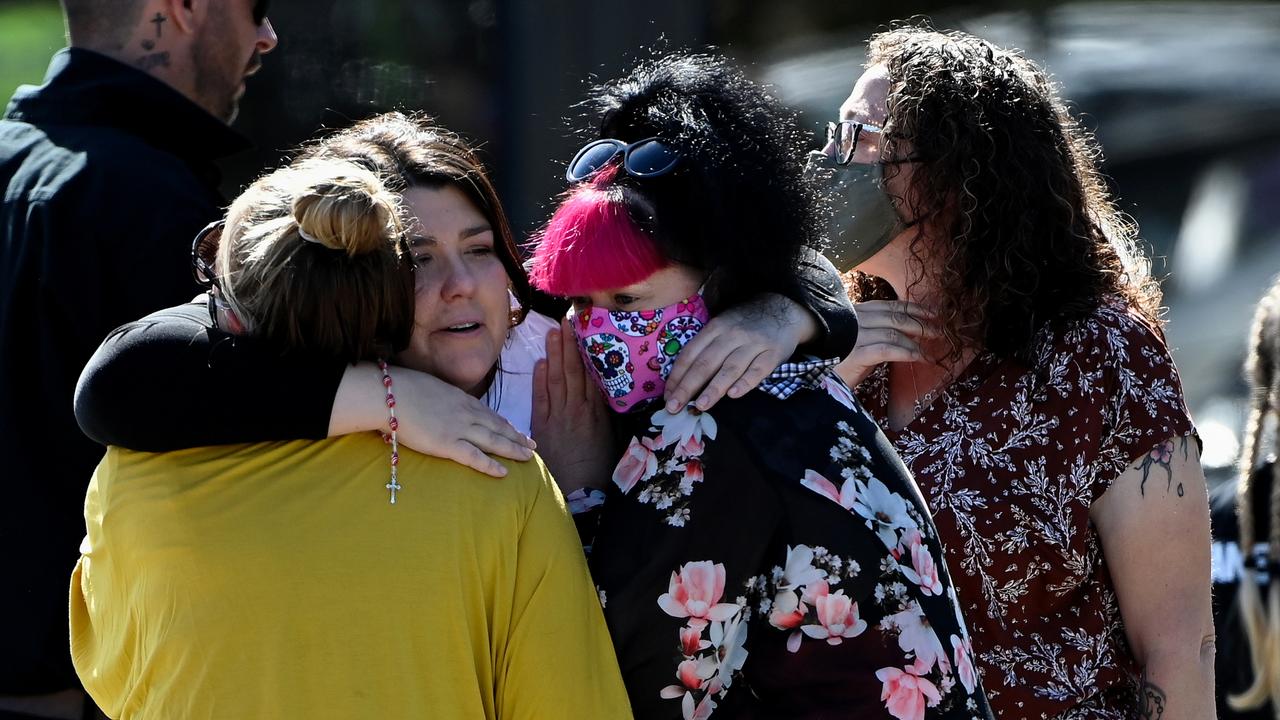 Georgie Gardam (centre) is comforted during at the funeral of her son Zane Mellor at the Mersey Gardens Chapel and Crematorium, in Devonport, Tasmania, Thursday, December 23, 2021. 12-year-old Zane Timothy John Mellor is one of six children who died after a jumping castle accident at Hillcrest Primary School in Devonport. (AAP Image/Bianca De Marchi) NO ARCHIVING