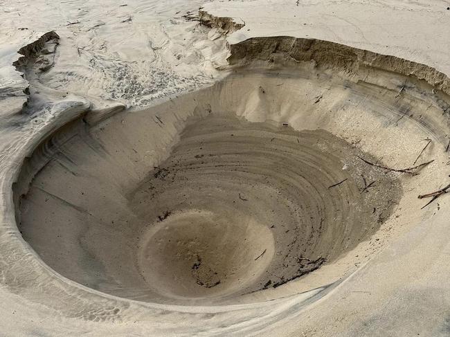 A two metre hole erupted in the middle of Main Beach. Picture: Supplied