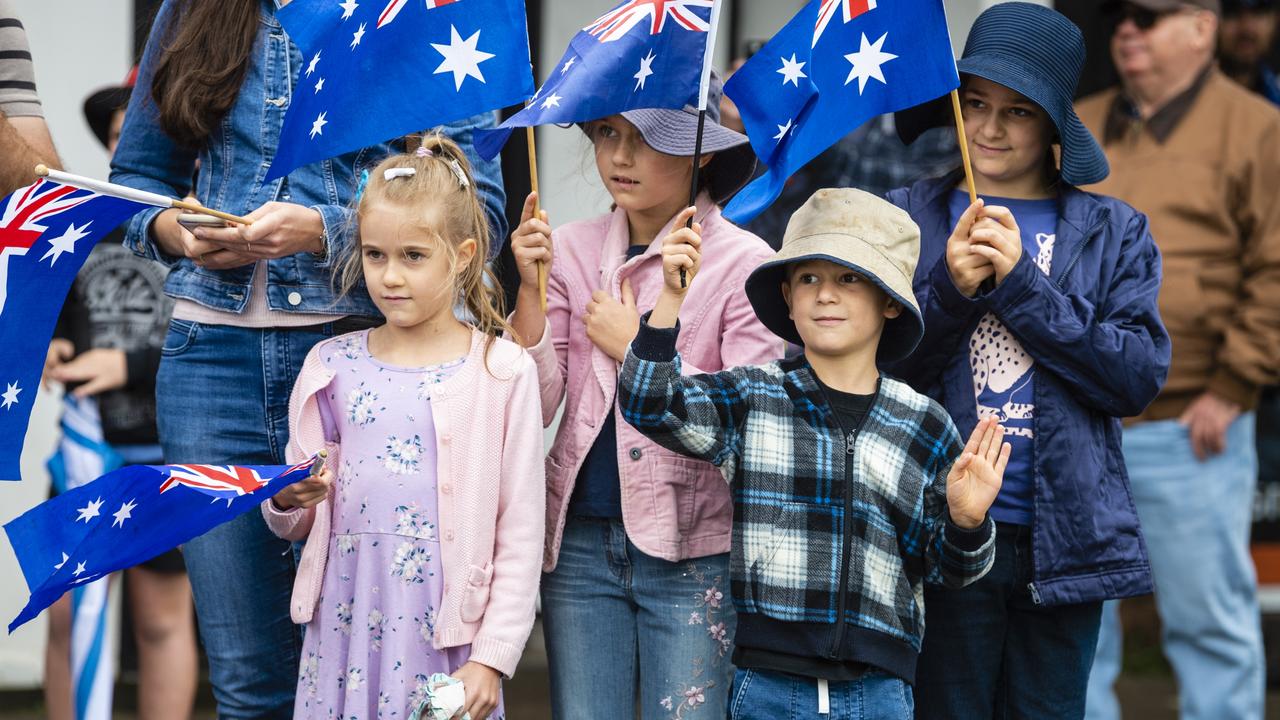 NWaving their aussie flags are (from left) Roxanne, Danielle, Marcus and Natasha Sharp during the Anzac Day morning march, Monday, April 25, 2022. Picture: Kevin Farmer