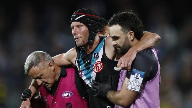 Brad Ebert is helped off after suffering another concussion in the 2020 preliminary final.