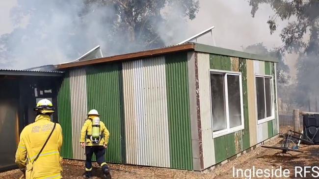 Tony Abbott (right) is seen about to enter the burning house in Bendalong. Picture: Ingleside RFS