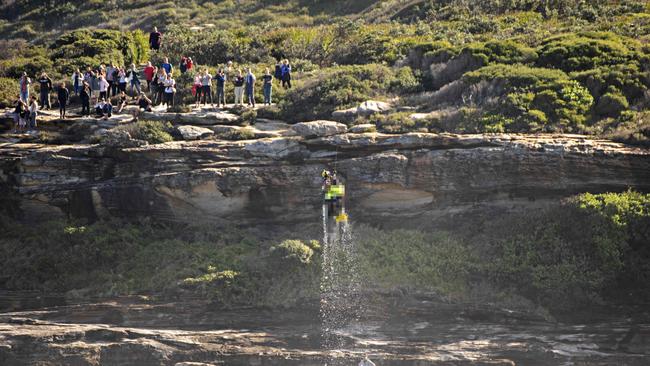 Westpac Lifesavers pulling a body out of the water in La Perouse after the boat overturned. Picture: Michael Ortuno