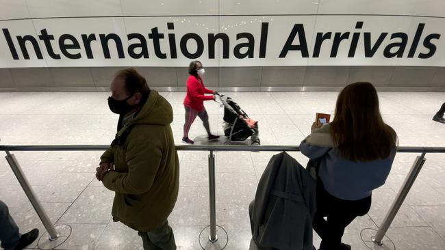 International passengers walk through the arrivals area at Heathrow Airport as the Omicron variant spreads across the globe. Picture: Getty Images