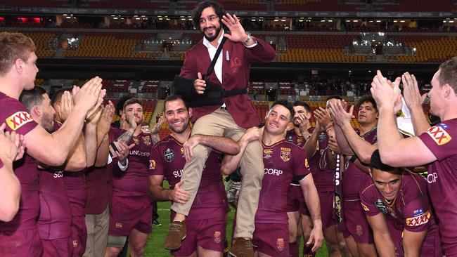 Johnathon Thurston is carried from the field by Cameron Smith and Cooper Cronk.