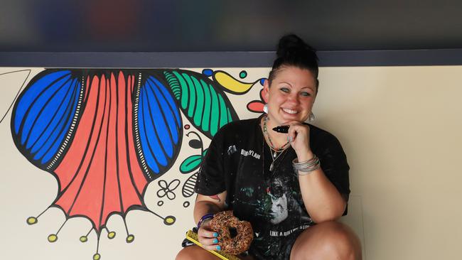 Bury Me Standing co owner Alesha Peckels works on a wall mural in the new dining area. Picture: Brendan Radke