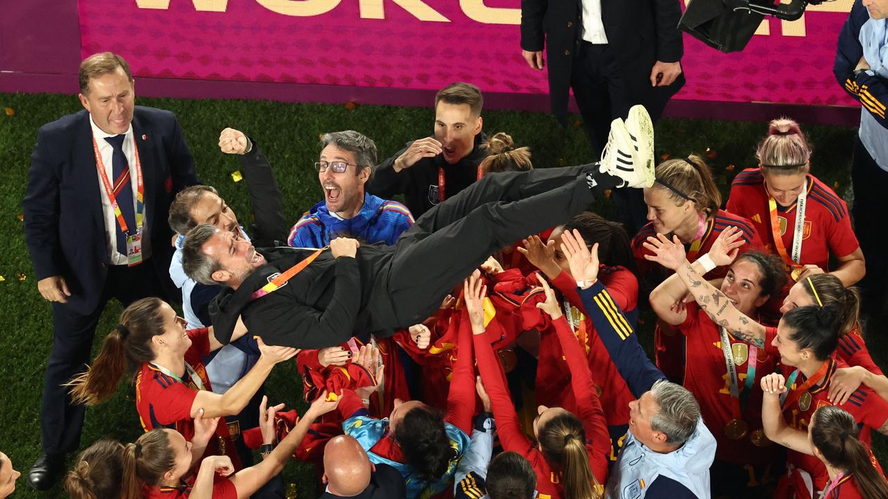 The players did lift him up. Photo by DAVID GRAY / AFP