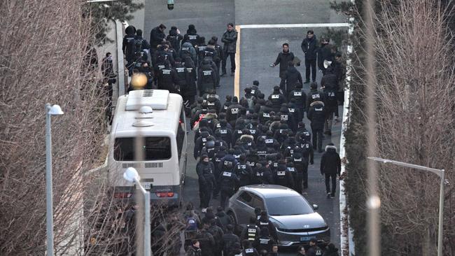 Police officers enter the compound of the presidential residence of the impeached president. Picture: Anthony Wallace/AFP