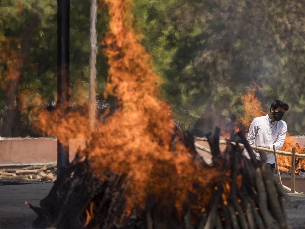 Multiple funeral pyres can be seen burning as people perform the last rites of their relatives who died of the coronavirus disease at a crematorium in the outskirts of New Delhi, India. Picture: Getty Images