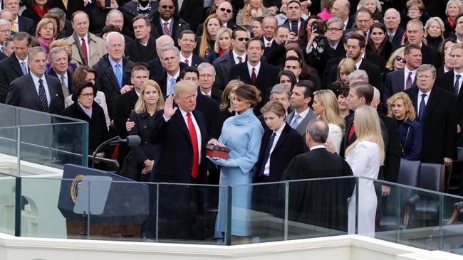 Supreme Court chief Justice John Roberts, right, administers the oath of office to Donald Trump as his wife Melania Trump holds the Bible and his son Barron Trump looks on, on the West Front of the US Capitol in 2017. Picture: Getty Images/AFP