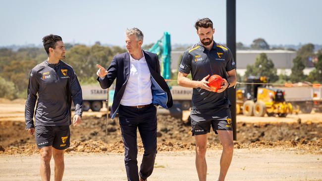 President of the Hawthorn Football Club Andy Gowers inspects the progress at Hawthorn's future club site in Dingley with players Chad Wingard and Conor Nash in December last year. Picture: Mark Stewart.