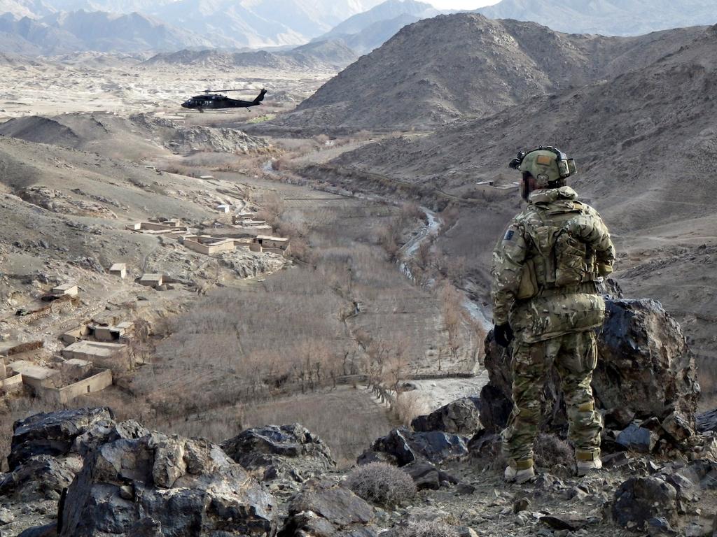 An Australian Digger looks over the valley of Chenartu, Afghanistan, where one of the alleged killings took place in 2012. The claim is denied by Mr Roberts-Smith.