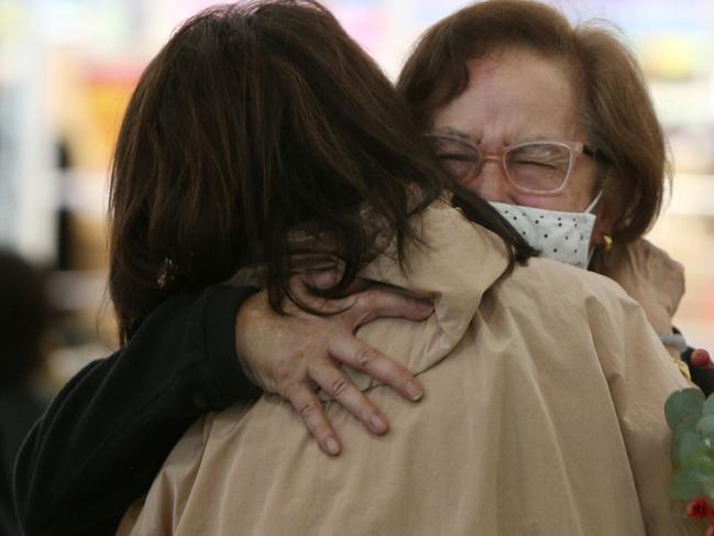 Sisters Lina and Adeline embrace at Sydney Airport today. Picture: Lisa Maree Williams/Getty Images